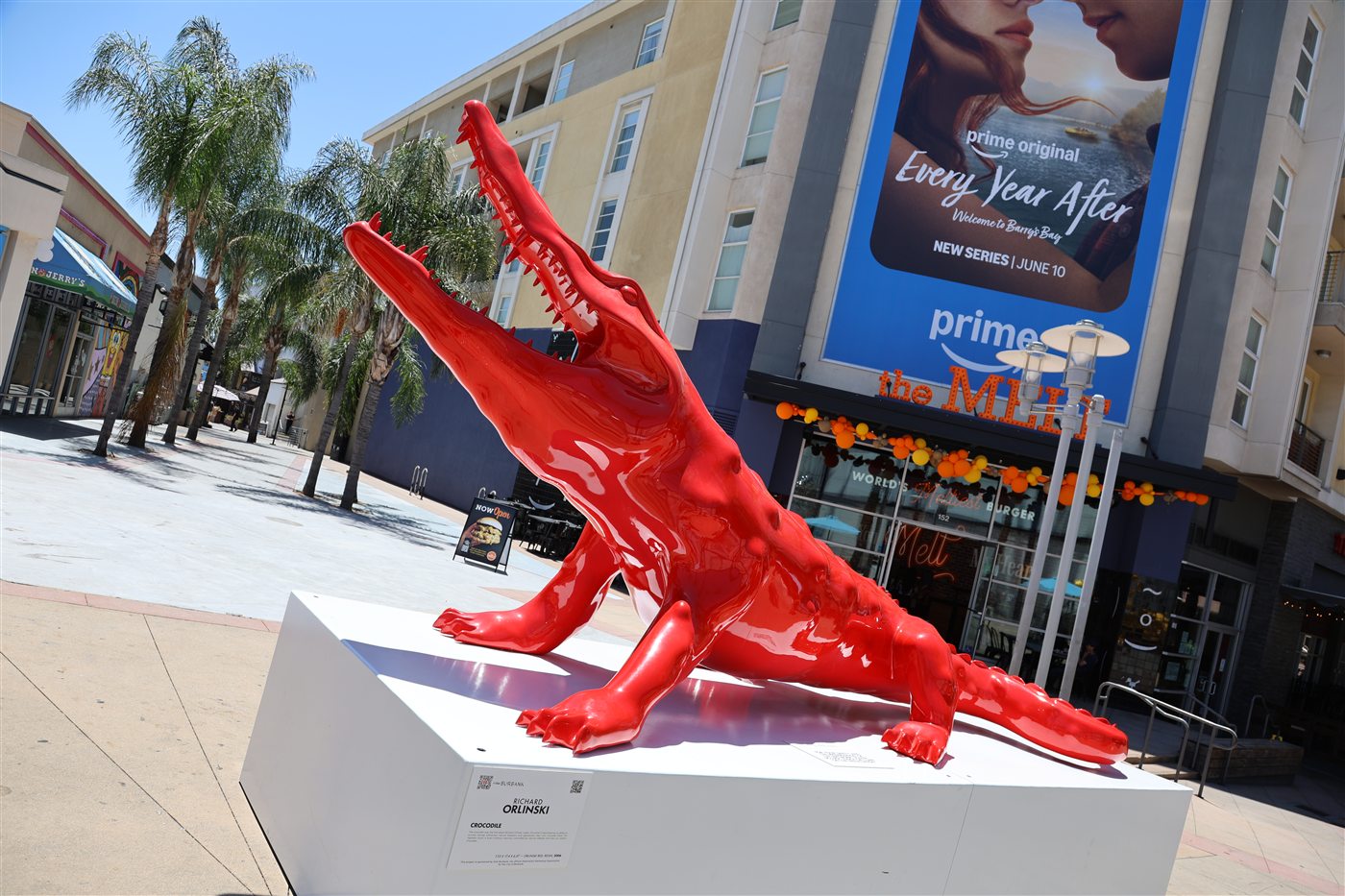 Red crocodile sculpture with downtown Burbank backdrop